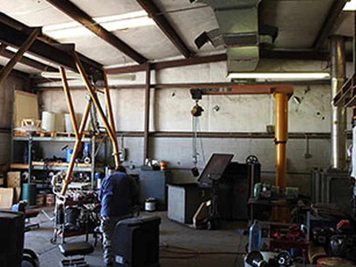 AEMS shop floor with gantry crane and motor repair workstations