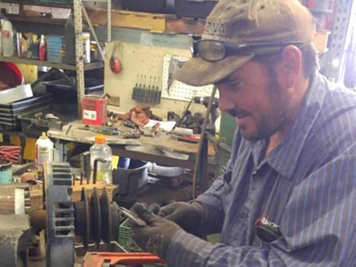 AEMS technician working on a large industrial electric motor